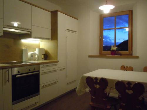 a kitchen with a table and a window at Feldererhof in Siusi