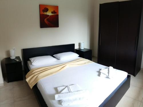a bedroom with two beds and two night stands at GOUGOUSIS apartments in Kalóyiros