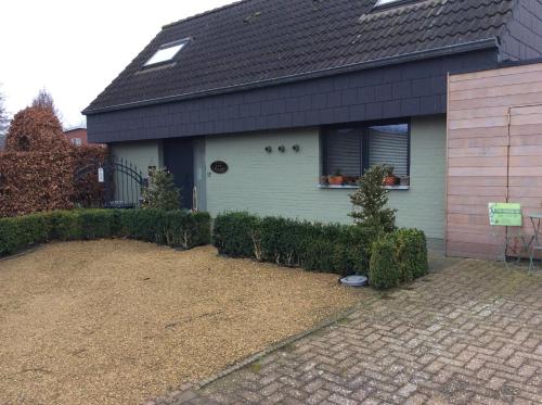 a house with a window and a yard at B&B T Pleintje in Pelt