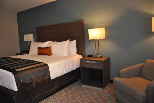 a hotel room with a bed and a chair at Nobile Hotel Parkway at Celebration Orlando Very Close to Disney Theme Parks in Orlando
