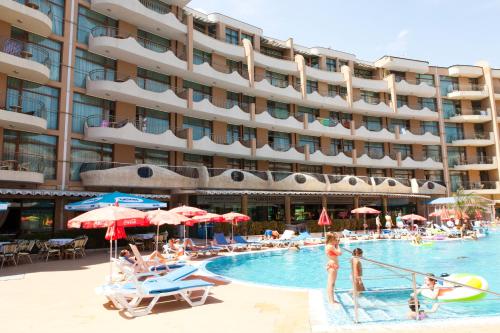 a hotel with a swimming pool with people sitting in it at Grenada Hotel in Sunny Beach