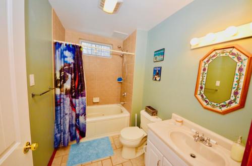 a bathroom with a tub and a toilet and a sink at Mt. Maplewood Split Chalet in Pocono Lake