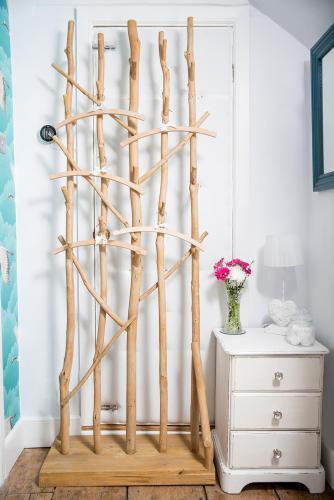 a display made out of tree branches in a room at The Cottage and The Nook in Gretton