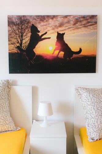 a painting of two dogs jumping in the sunset at Steira-Studios in Ehrenhausen