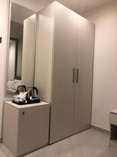 a room with two white cabinets and a mirror at B&B Rossini Luxury in Rende