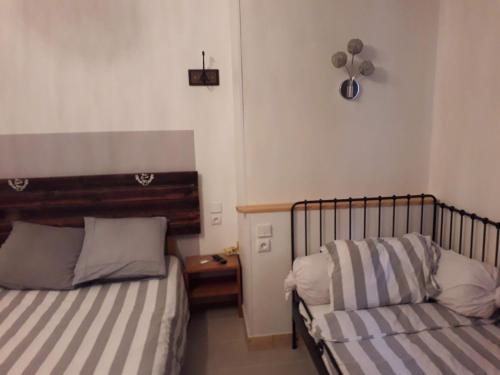 a bedroom with two beds and a night stand with a table at Chez Celine et Philippe appartement dans propriété de charme avec piscine in Le Fossat