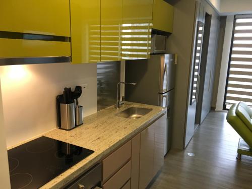 a kitchen with a sink and a refrigerator at Enjoy In Bogotá in Bogotá