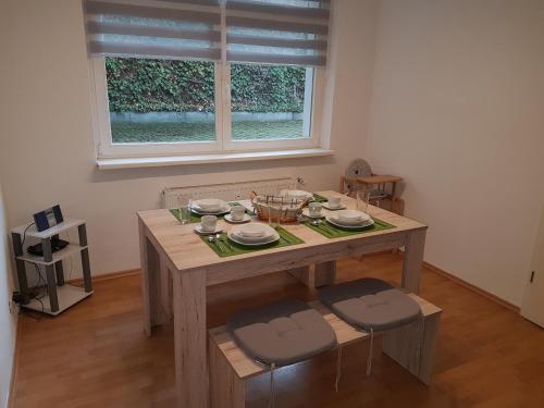 a dining room table with two chairs and a window at Altstadtflair in Wernigerode