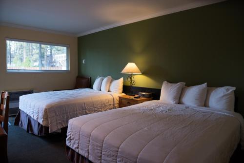 a hotel room with two beds and a window at Tea Garden Lodge in South Lake Tahoe