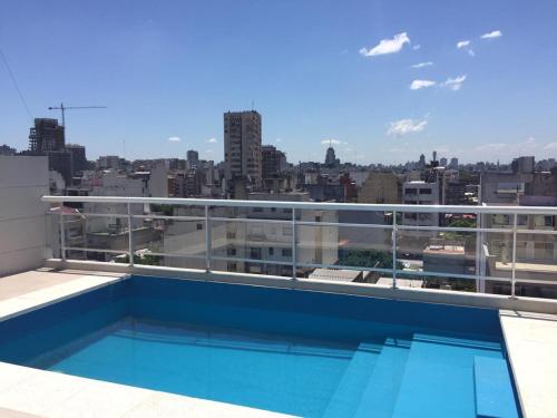 a balcony with a swimming pool on top of a building at INES in Buenos Aires