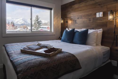 a bedroom with a large bed with a tray on it at Snow Valley Lodging in Fernie