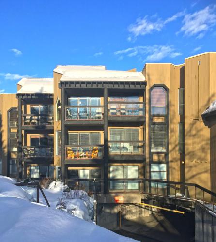 an apartment building with snow in front of it at The Ironwood on Blueberry Hill in Whistler