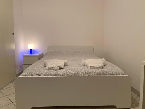 a bedroom with a white bed with two towels on it at Berthollet 24 in Turin