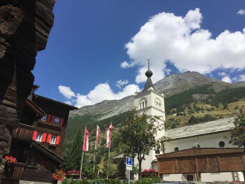 a church with a cross on top of a building at Monte Rosa D 412 in Täsch