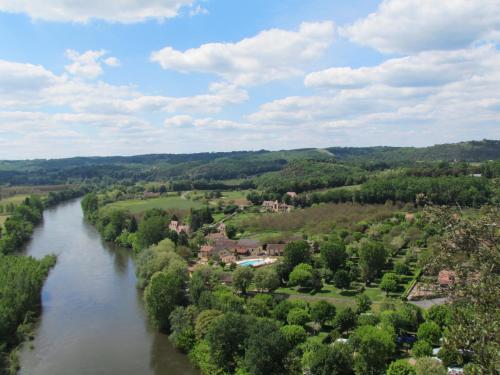 an aerial view of a river in a town at La Maison de Tari in Vitrac