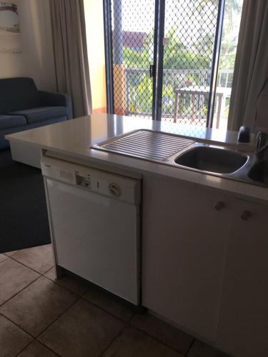 a kitchen counter with a sink and a window at Portobello Resort Apartments in Gold Coast