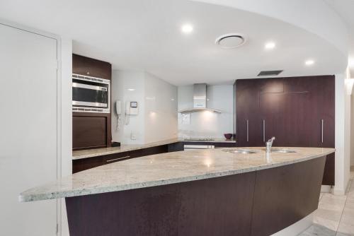 a kitchen with a large island in the middle at Mantra Sirocco in Mooloolaba