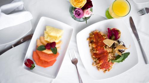 a white table with two plates of food on it at Hotel Las Puertas de Tepoztlan in Tepoztlán