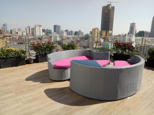 two chairs and a couch on top of a building at V Boutique Hotel in Phnom Penh