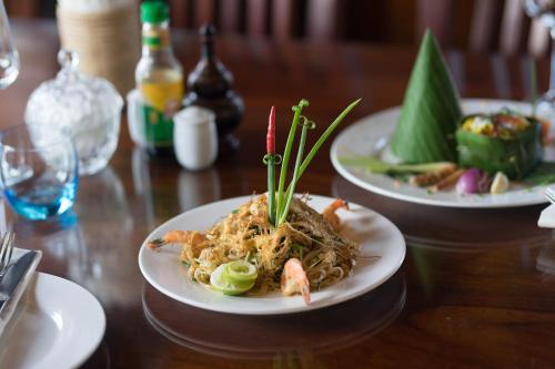 a plate of noodles with shrimp on a table at Okay Palace Hotel in Phnom Penh