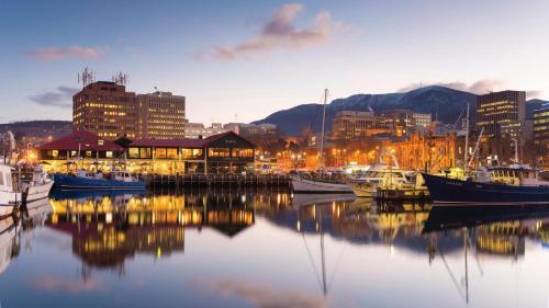 a marina with boats in the water and a city at Hotel Grand Chancellor Hobart in Hobart