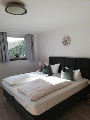 a large bed in a bedroom with a window at Apartmenthaus Kaiser Friedrich in Potsdam