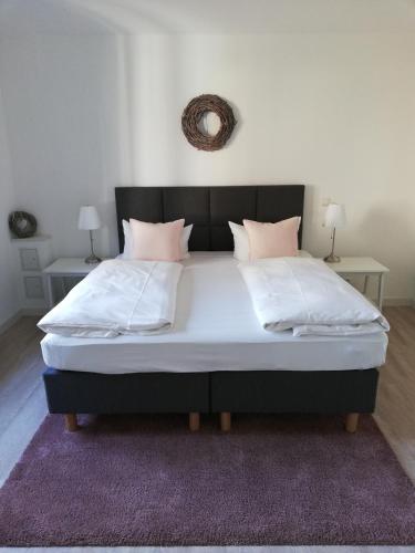 a bedroom with a large bed with a purple rug at Apartmenthaus Kaiser Friedrich in Potsdam