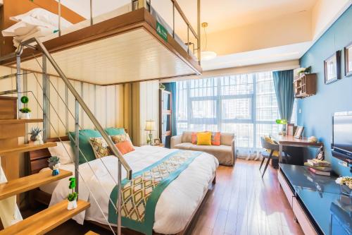 a bedroom with a bunk bed and a couch at Westlake 7 Service Apartment in Hangzhou