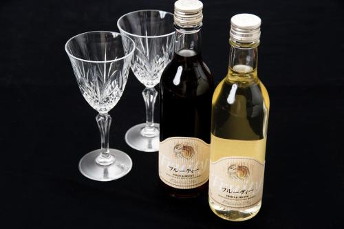 two bottles of wine and two wine glasses at Kyo no Minshuku Ohara no Sato in Kyoto