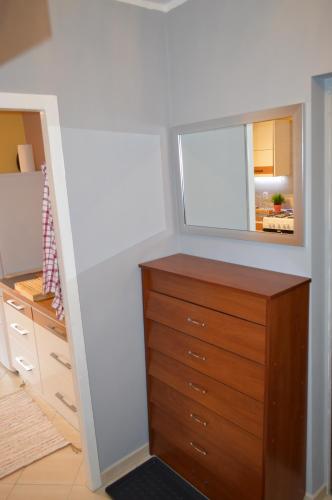 a bedroom with a dresser and a mirror at Apartament dla turystów in Tychy
