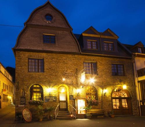a large brick building with lights on it at night at Winzerhof Brachtendorf in Alken
