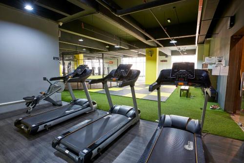 a gym with three exercise bikes in a room at B Lot Hotel in Kuala Lumpur