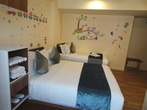 a bedroom with a large white bed in a room at five6 Hotel Splendour in Singapore