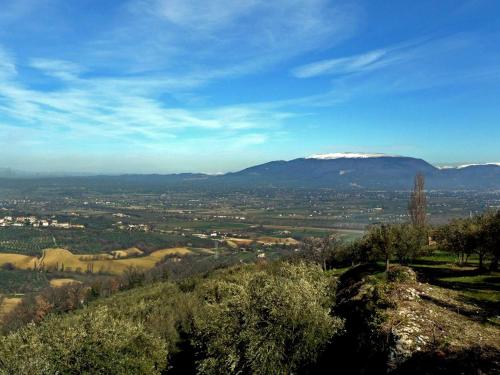 a view from the top of a hill with a snow covered mountain at Vecchio Forno Casa Vacanze in Montefalco