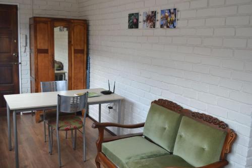 a room with a table and chairs and a bench at Apple Orchard Cottage in Harrismith