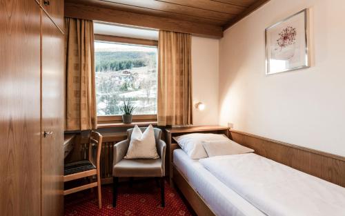 a hotel room with a bed and a window at B&B Villa Angelino in Ortisei