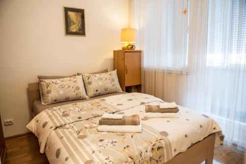 a bedroom with a bed with towels on it at Central Place in Trebinje