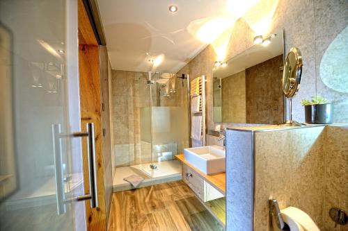 a bathroom with a sink and a shower at Landhotel Talblick in Neuweiler