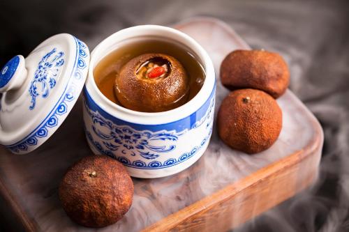 a plate with a cup of tea and some food at Shenzhen Futian Wyndham Grand in Shenzhen