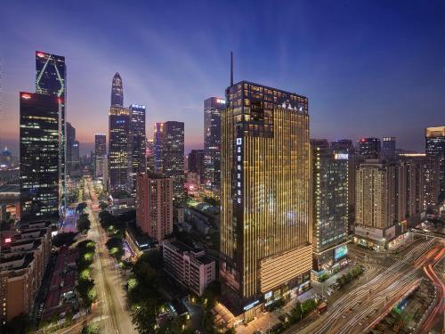 a city skyline at night with many tall buildings at Shenzhen Futian Wyndham Grand in Shenzhen