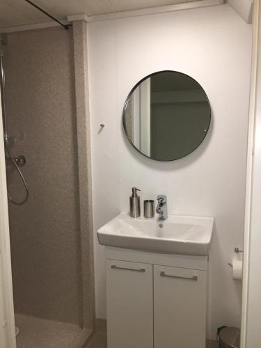 a bathroom with a white sink and a mirror at The Atlantic view guest house, Sandavagur, Faroe Islands in Sandavágur