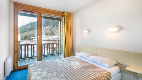 Letto o letti in una camera di Vacancéole - Résidence Les Chalets et Balcons De La Vanoise