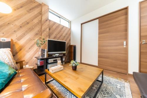 a living room with a couch and a table at Tasuki in Tokyo