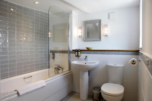 a bathroom with a sink and a toilet and a shower at The Rose and Crown in Warwick