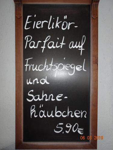a chalkboard sign with writing on a wall at Gasthaus Stadt Bad Sulza in Bad Sulza