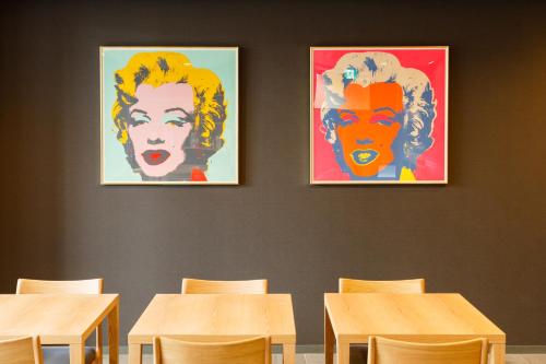 a classroom with tables and posters on the wall at Hotel Ninja Black in Kyoto
