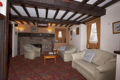 a living room with two couches and a fireplace at Seven Stars in Hay-on-Wye