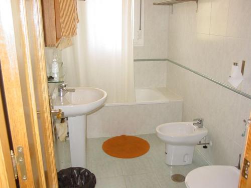 a bathroom with a sink and a toilet at Villa Mar - now with HEATED POOL! in Isla Canela