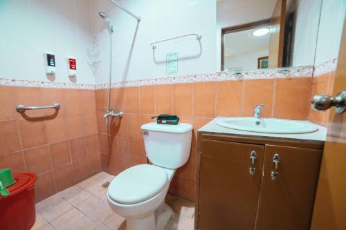 a bathroom with a toilet and a sink at RedDoorz at La Casa Guesthouse former RedDoorz at Tamarind Street Angeles City in Angeles