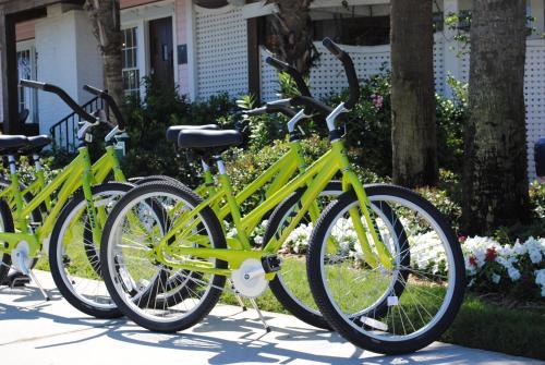 three lime green bikes parked in front of a house at Port d'Hiver Bed and Breakfast in Melbourne Beach